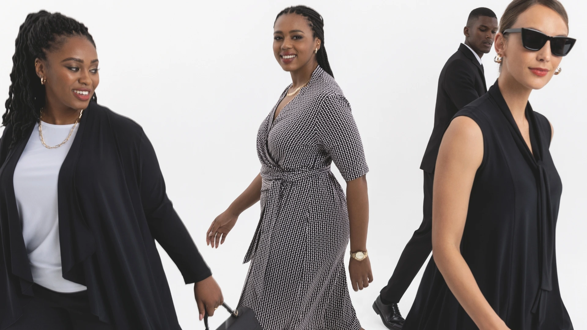 A team of professional ladies wearing black and white coordinated office wear.
