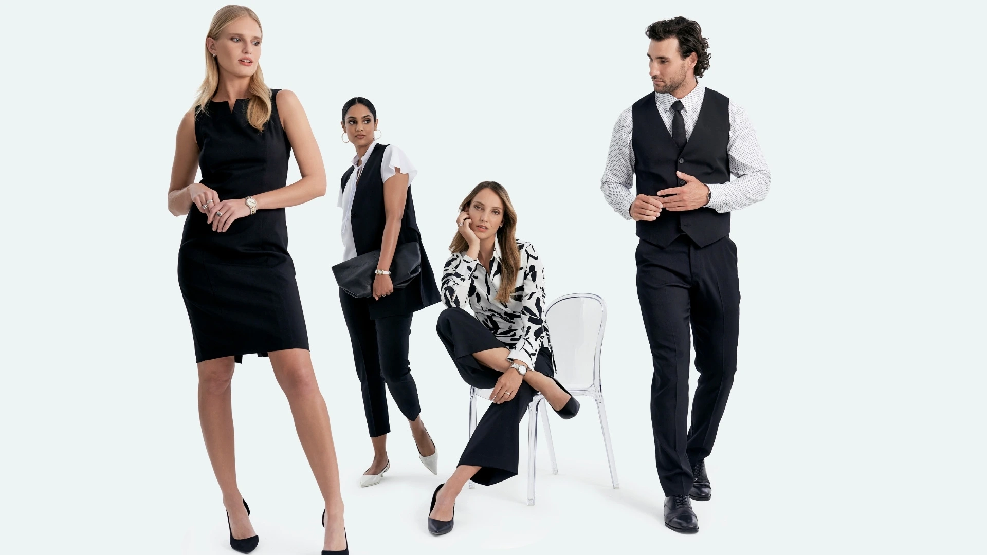 A team of employees wearing black and white coordinated office wear.