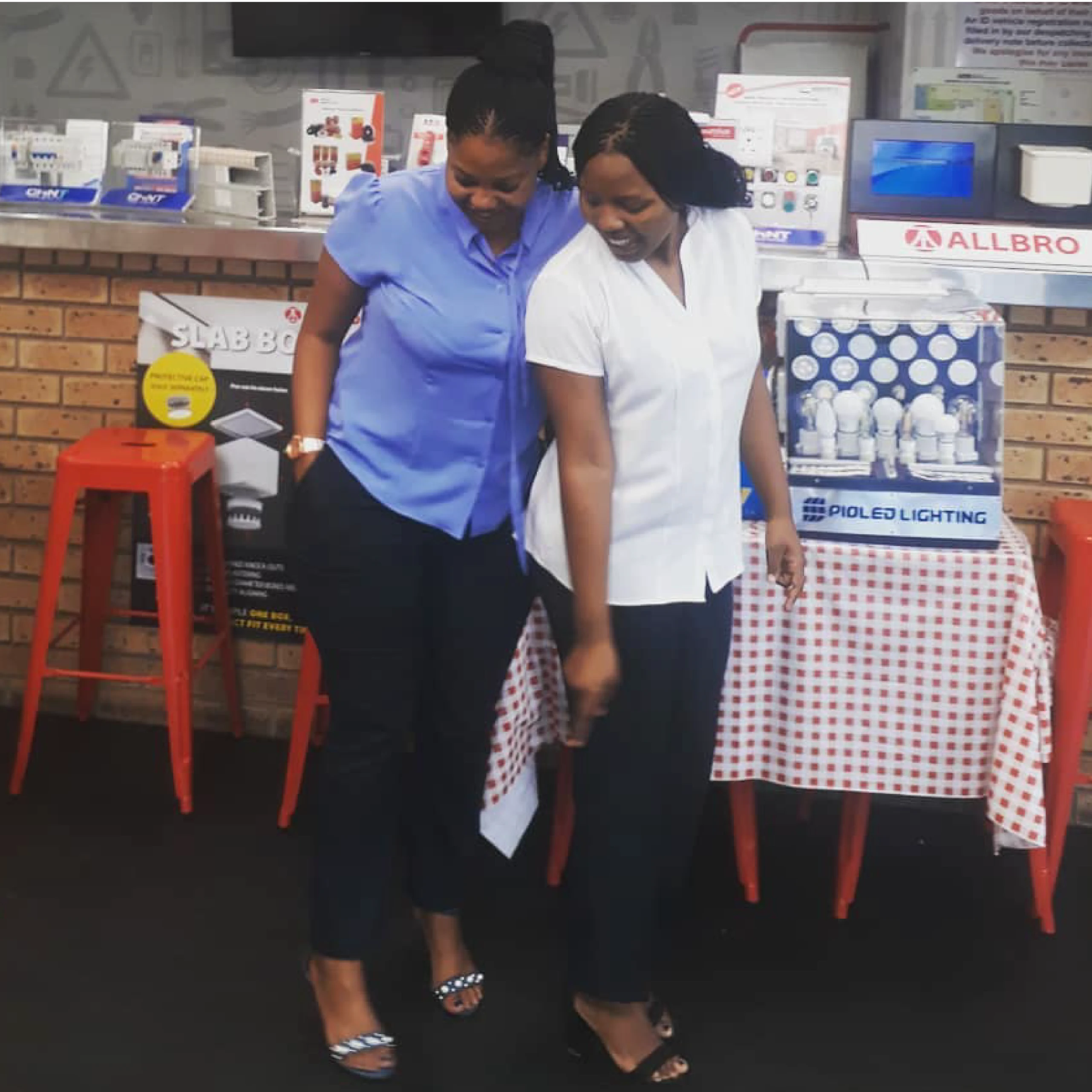 Ladies Wearing True Blue And Pearl White Corporate Blouses and Clothing By Imagemakers