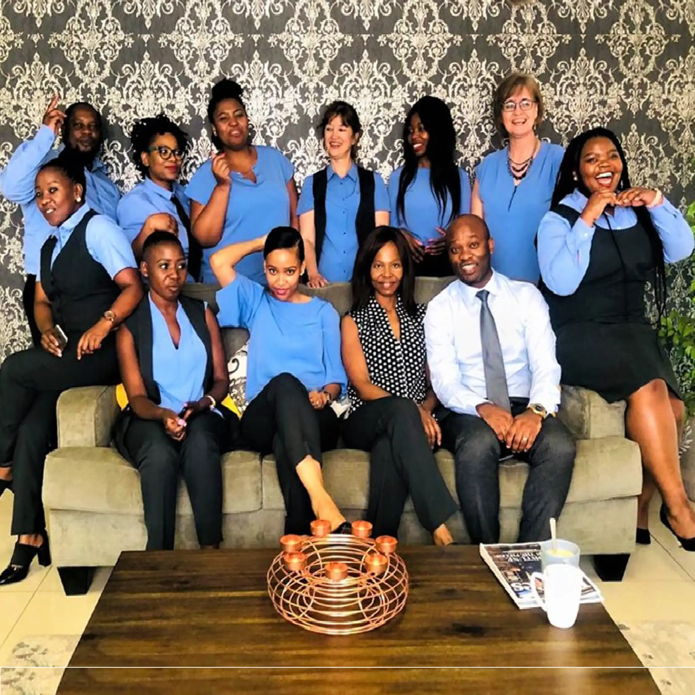 Team of Men and Women in True Blue and Navy Business Uniforms by Imagemakers