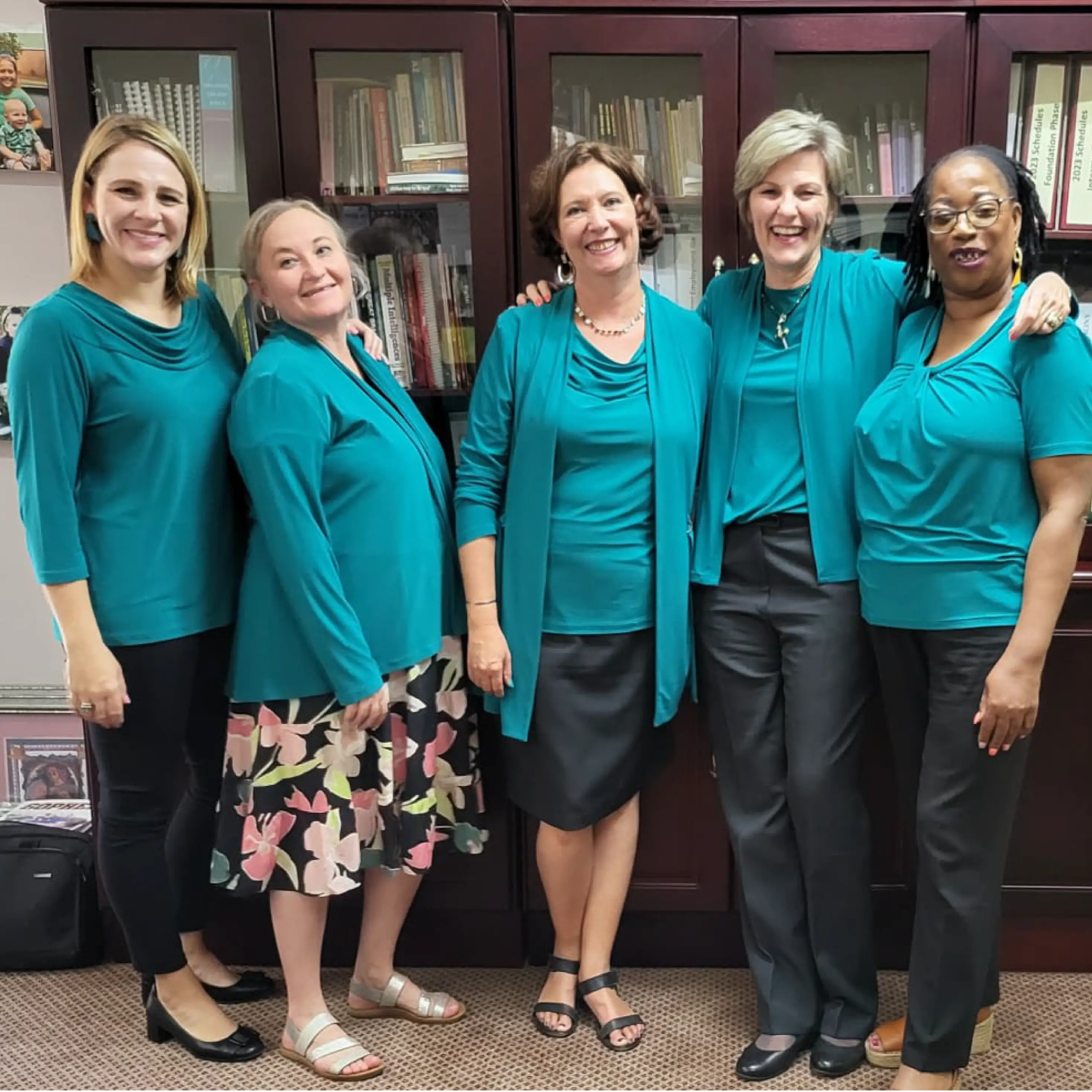Team of Women Dressed in Jade and Black Office Clothing