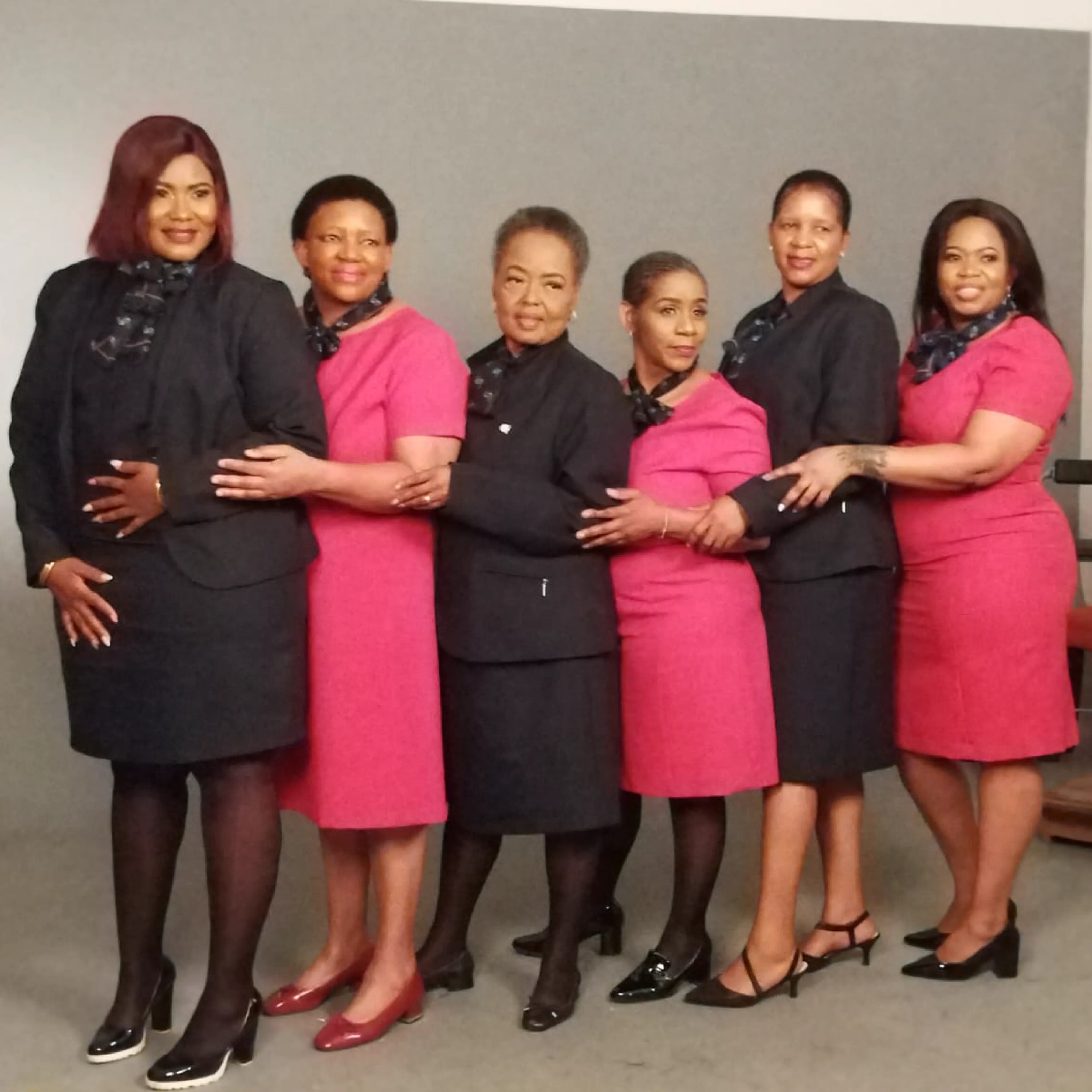 Ladies Wearing Red and Black Corporate Dresses for Work by Imagemakers