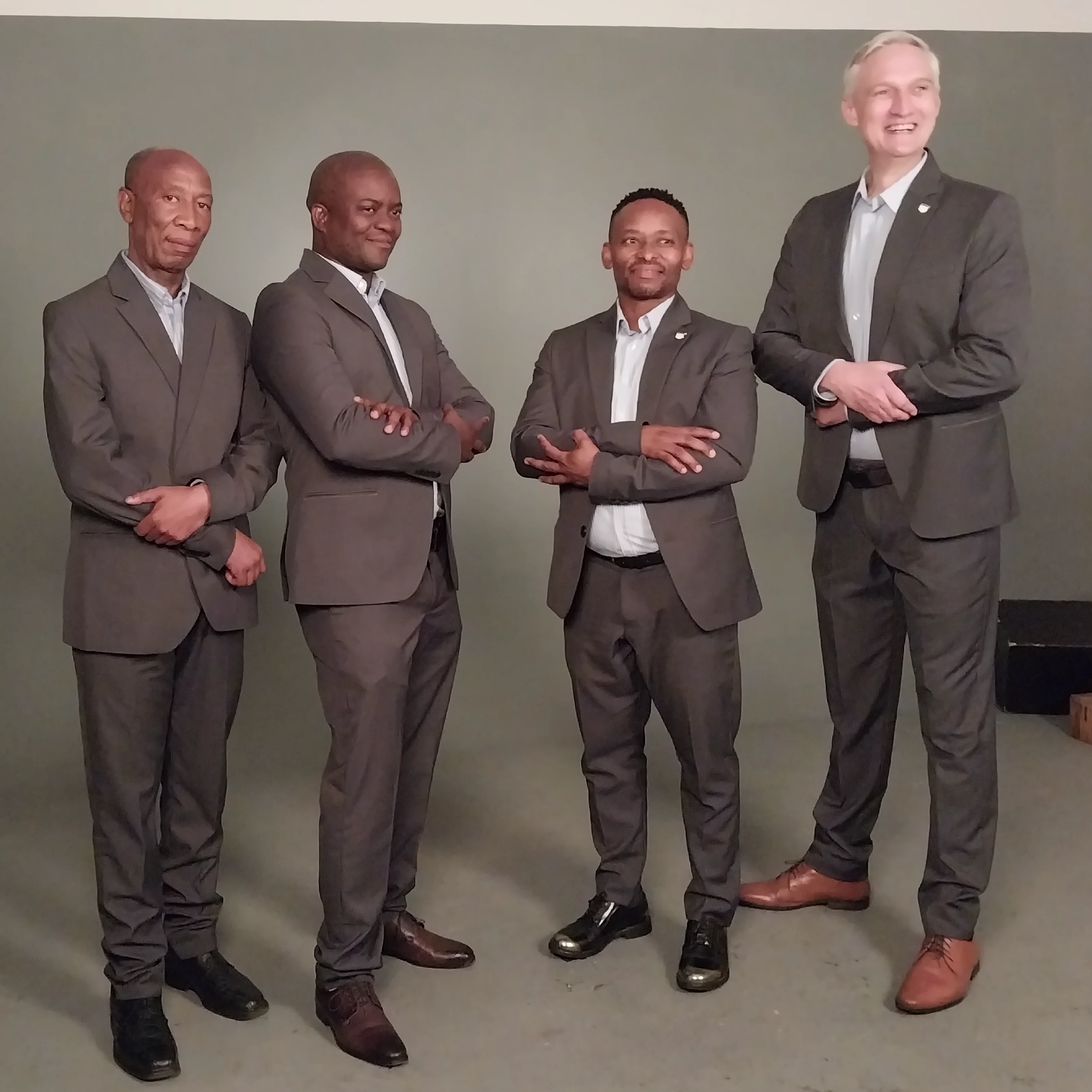 Team Of Men Wearing Grey Corporate Suits and White Formal Shirts Supplied By Imagemakers